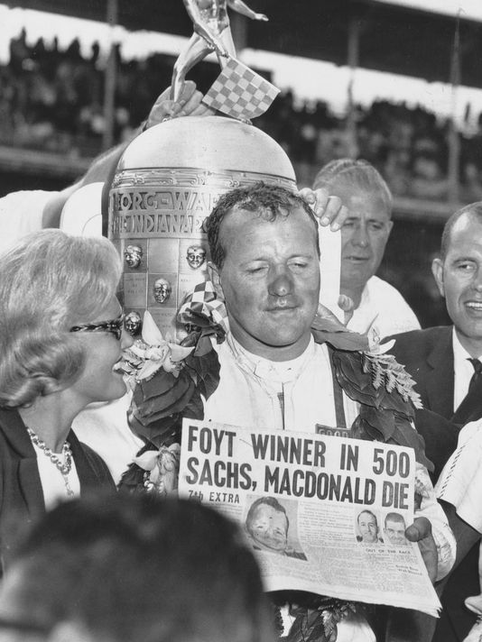 1964 Indy 500 winner AJ Foyt holds newspaper about Dave MacDonald and Eddie Sachs death